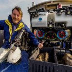 Electrical engineer and ROV pilot Dave Wright gives a thumbs up to rock samples he collected with ROV Yogi at the bottom of Yellowstone Lake. Credit: Daniel R. Rogers, GFOE